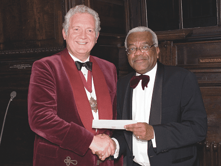 Sir Trevor MacDonald receives a cheque for £30,000 from the Master, Sir Jeremy Hanley, for the National Missing Persons Helpline in 2006