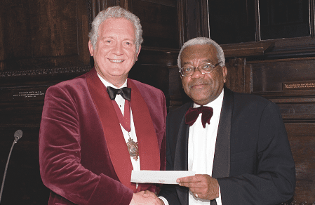 212-Sir-Trevor-MacDonald-receives-a-cheque-for-£30000-from-the-Master-Sir-Jeremy-Hanley-for-the-National-Missing-Persons-Help